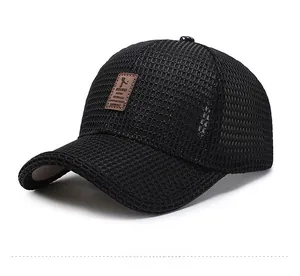 Close-up of black breathable mesh fabric and brown leather patch on baseball cap