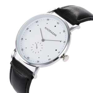 Detail of the slim silver alloy case and white minimalist dial of the business watch
