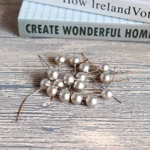 Champagne pearl berries with flexible wire stems for DIY Christmas tree decor on wood
