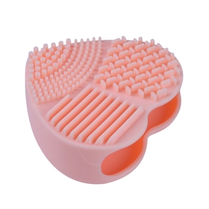Pink heart-shaped silicone makeup brush cleaning mat with various textures for deep washing