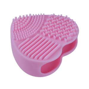 Pink heart-shaped silicone makeup brush cleaning mat with multiple scrubbing textures