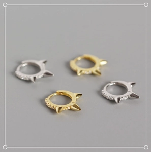 Detailed close-up of S925 sterling silver rivet hoop earrings with zircon accents