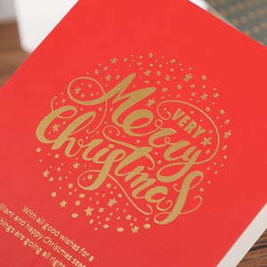 Elegant red Christmas card with premium gold foil Merry Christmas script and starry patterns