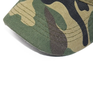 Detailed close-up of jungle camouflage baseball cap brim with durable reinforced stitching