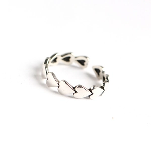 Retro S925 sterling silver ring with multiple linked heart shapes on white background