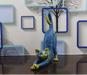 Detail of blue and gold modern resin cat sculpture with artistic mottled texture