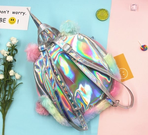 Macro shot of colorful plush trim and adjustable silver straps on a laser unicorn backpack
