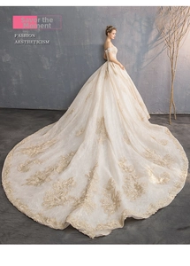 Side view of luxury off-the-shoulder wedding dress with long lace train and embroidery