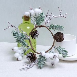 Christmas wreath with pine cones and white berries featuring realistic snow effect