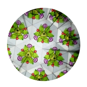 Internal view of a classic paper kaleidoscope showing symmetric colorful geometric patterns