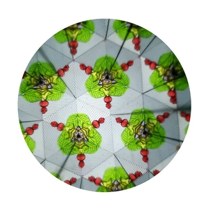Macro view of colorful geometric patterns inside the kaleidoscope with glass beads