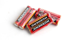 Close-up of Husheng AA 1.5V batteries showing the black and red design for toys