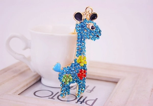 Detail of crystal giraffe keychain with blue rhinestones and colorful floral enamel