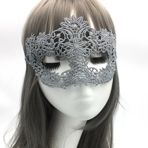 Detailed view of silver embroidered lace mask with intricate phoenix wing pattern