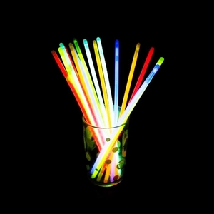 Vibrant multi-color glow sticks in a clear glass container for concert party events