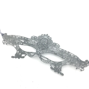 Detailed close-up of a silver lace masquerade mask with intricate cutout patterns