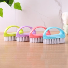 Row of four colorful long-handle sponge cleaning brushes on a wooden surface
