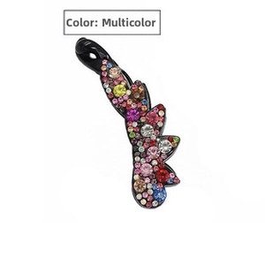 Detail of banana hair clip with vibrant multicolor rhinestones on black resin base