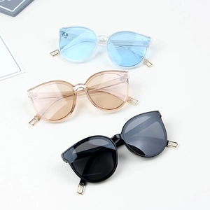 Three pairs of fashionable kids sunglasses with colorful lenses and gold metal temples