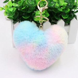 Close-up of fluffy rainbow heart keychain with soft faux fur and gold metal clasp