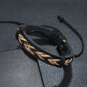 Adjustable woven leather bracelet in black and brown on a sleek textured background