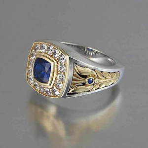 Detail of two-tone men's ring with square blue stone and side floral engraving