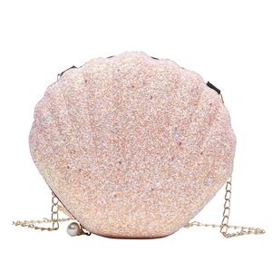 Pink shell shaped crossbody bag with glitter finish, gold chain, and pearl zipper charm