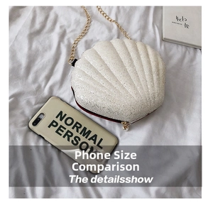 Top view of pearl white shell shaped clutch bag with glitter finish and gold chain