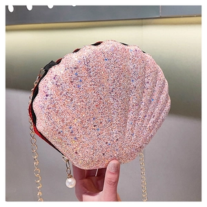 Pink sequin shell-shaped crossbody bag with gold chain and a white pearl charm detail