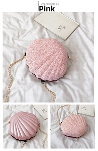 Detail of pink glitter shell crossbody bag with pearl zipper and gold chain strap