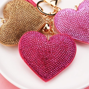 Close-up of sparkling rhinestone heart keychains in pink, rose, and gold colors