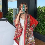 Detail of red floral print kimono cardigan fabric and bohemian pattern on female model