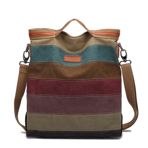 Striped canvas tote bag with brown leather handles and a detachable shoulder strap