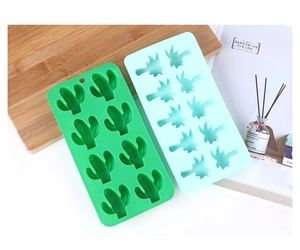 Detailed top view of green and light blue cactus-shaped silicone ice cube molds on wood
