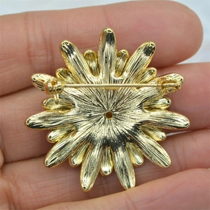 Golden enamel daisy flower brooch featuring a secure pin back clasp for fashion accessories