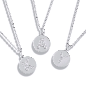 Macro detail of silver S925 letter pendants K, A, Y with sparkling zircon pavé