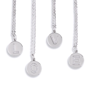 Detailed close-up of four silver necklaces featuring sparkling crystal LOVE letter pendants