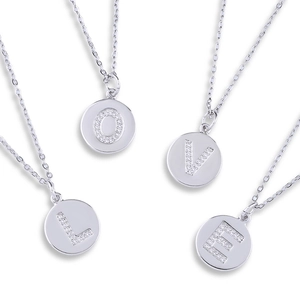 Detail of four silver necklaces with zircon-studded LOVE letter coin pendants