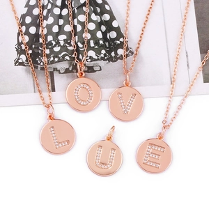 Detailed close-up of rose gold letter pendants L-O-V-E-U with shimmering pavé crystals