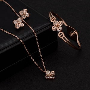 Rose gold titanium steel jewelry set with clover necklace, bracelet and earrings