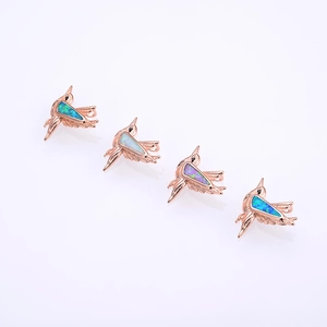 Hummingbird pendant set in rose gold finish with multicolor opal inlay on white background