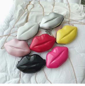 Flat lay of lip-shaped patent leather chain bags in seven vibrant glossy colors