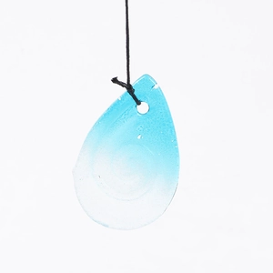 Detail of a blue gradient water-drop glass pendant with a black hanging cord on top