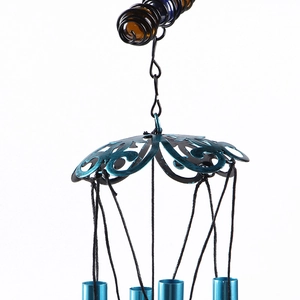 Detail showing blue metal dome with hollow patterns and blue tubes of the angel wind chime