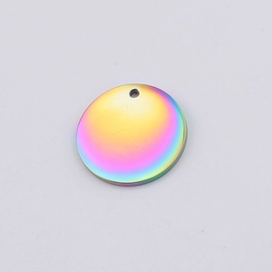 Macro shot of circular rainbow mirror finish stainless steel pendant with top hole