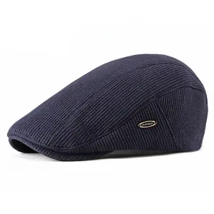 Navy blue waffle knit ivy cap for men featuring a metallic side logo on a white background