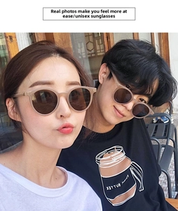 Detailed view of matte milk tea round sunglasses with dark lenses on a female model