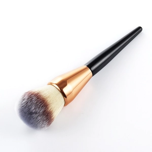 Detail of soft synthetic bristles and rose gold ferrule on a large powder makeup brush
