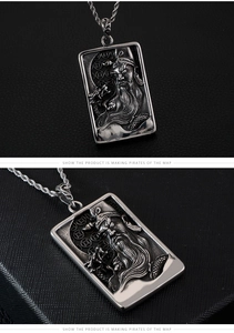 Macro view of vintage silver Guan Yu relief pendant with intricate dragon patterns and chain