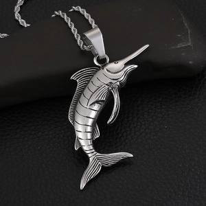 Polished stainless steel swordfish pendant necklace on a dark stone background